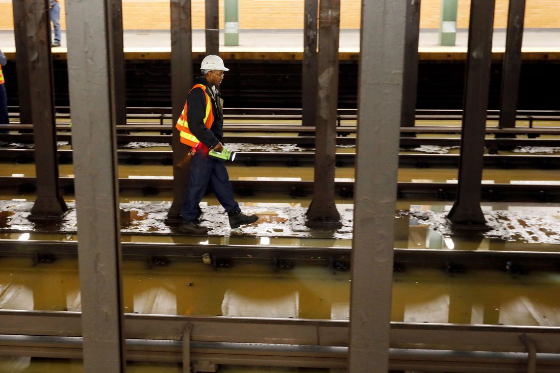 A worker surveys the flooded Lincoln Center subway station, in New York, . A water main break flooded streets on Manhattan's Upper West Side near Lincoln Center and hampered subway service during the Monday morning rush hour